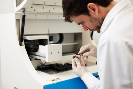 a man in a labcoat doing lab tests