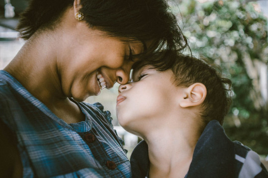 a mother who looks at her son laughing