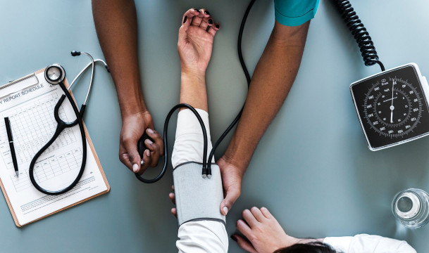 a health specialist who takes a woman pressure