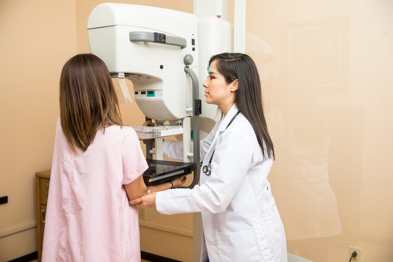 a doctor with his patient doing a mammogram